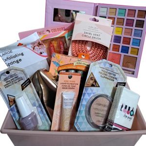 The Automotive Basket, a pink basket brimming with an assortment of beauty products like nail polish, exfoliating sponges, makeup brushes, liquid foundation, a large eyeshadow palette, lip glosses, and a contour and blush kit. All the items are vibrantly packaged as if they deserve a spotlight in an automotive showroom for beauty enthusiasts.