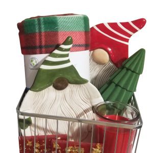 A festive gift basket featuring the Automotive Basket, which includes a red and green Christmas blanket, ceramic gnome figures in red and green hats, a green tree-shaped ornament, a red and white candle in a glass holder, and a red gift box with gold decorations—all perfectly organized in an automotive-themed metal wire basket.