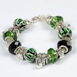 The Emerald Isle Irish Bracelet eloquently captures the spirit of Ireland with its blend of green, black, and silver beads. The green beads, echoing the beauty of the Emerald Isle, are adorned with intricate swirls of black and white patterns. These are complemented by faceted black beads and exquisitely crafted silver ones, making this bracelet a true circular masterpiece.