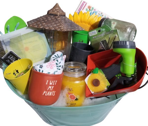 An Automotive Basket brimming with gardening-themed delights: a candle, yellow flower picks, a small watering can with "I wet my plants" text, garden gloves, a mini garden tool set, plant markers, a teal pot, gardening clippers, a sunflower decoration, and more. Perfect for the green thumb in your life!