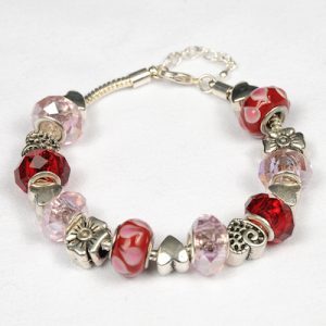 The Valentines Day Wish Bracelet is a stunning silver bracelet adorned with an assortment of beads, including faceted glass, red and pink acrylic, and charming silver heart and flower charms. Ideal for Valentine's Day, it boasts a lobster clasp and an adjustable chain for the perfect fit.