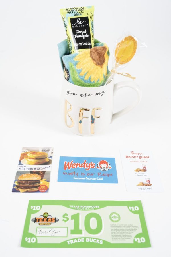 The "You are my BFF Mug Gift Basket with Free Food Certificate" includes a white BFF mug inscribed with "You are my BFF" that holds a sunflower-patterned towel, a tube of body lotion, and a lollipop. Surrounding the mug are food certificates for Wendy's, Chick-fil-A, McDonald's, as well as a $10 Texas Roadhouse gift card.