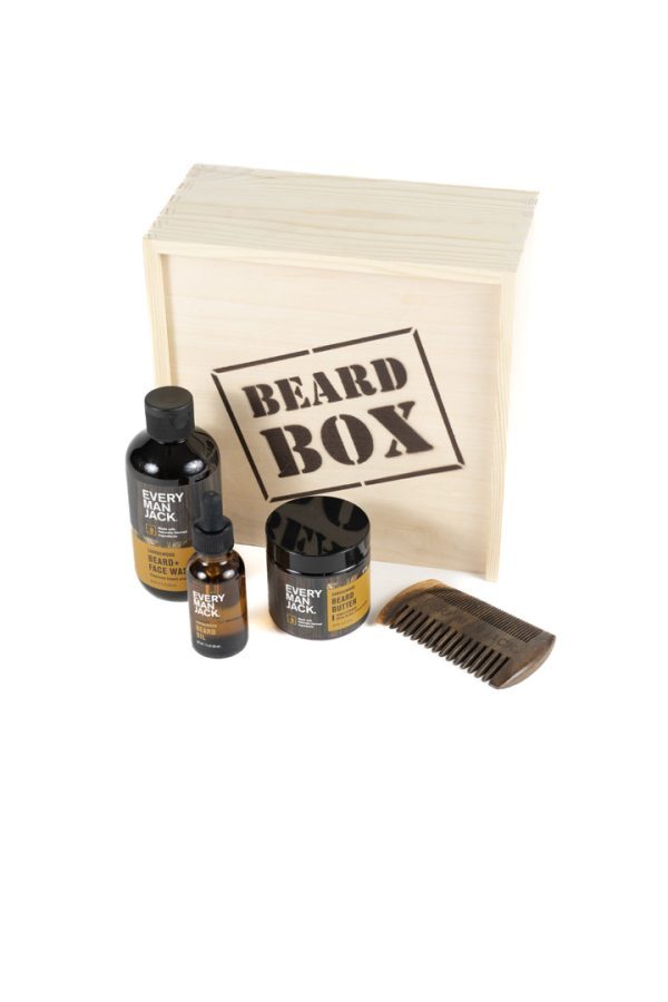 The Adult Gambling Night Basket includes a wooden box labeled "Beard Box" and a selection of grooming products, such as a wooden comb, a bottle of beard oil, a bottle of beard balm, and a bottle of beard wash, all branded "Every Man Jack." These items are neatly arranged in front of the box, making it ideal for any adult's nightly grooming routine.