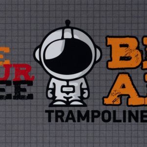 The advertisement for "Big Air Trampoline Park" features a cartoon astronaut in the center. To the left, text in red and black reads "One Hour Free." To the right, "BIG AIR" is written in bold orange letters above "Trampoline Park." Gift cards are available at 25% off for more trampoline fun!