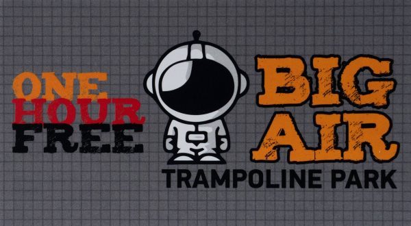 The advertisement for "Big Air Trampoline Park" features a cartoon astronaut in the center. To the left, text in red and black reads "One Hour Free." To the right, "BIG AIR" is written in bold orange letters above "Trampoline Park." Gift cards are available at 25% off for more trampoline fun!