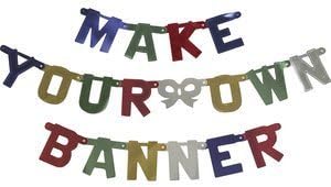 A banner composed of colorful, uppercase letters spells out "MAKE YOUR OWN BANNER" in three rows. The letters come in a vibrant mix of blue, red, green, yellow, and white. Linked together with small fasteners, this Build a Banner - Make your Own Banner Kit lets you create a uniquely personalized banner.