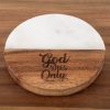 The "God Vibes Only - Round" coaster, made of wood and marble, sits elegantly on a wooden surface. This beautifully balanced piece features half wood and half white marble, with the text "God Vibes Only" engraved on the wooden portion.