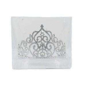 The Deluxe Tiara, showcased in a clear plastic box, features intricate scrollwork and sparkling rhinestones. Its central peak and symmetrical design make it a regal accessory perfect for occasions such as weddings, proms, or pageants.