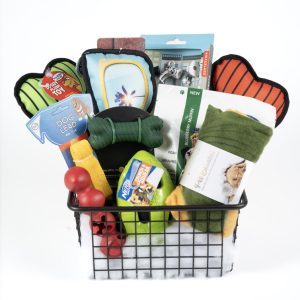 The Adult Gambling Night Basket contains an array of pet supplies, such as dog toys, a leash, waste bags, a grooming tool, a blanket, and other essentials—all vibrantly and neatly organized for your furry friend's care. Ideal for any adult pet owner to conveniently access day or night.