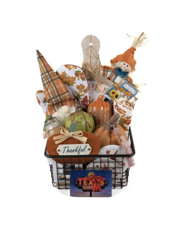 The Fall Harvest Medium Basket with Texas Roadhouse $40 Dinner for Two showcases a rustic black wire container brimming with autumnal decor items such as plaid fabric pumpkins, a "Thankful" sign, an orange pumpkin, a wooden cutting board, a plush scarecrow, and a small sunflower pillow. Highlighted prominently is the Texas Roadhouse gift card for Dinner for Two worth $40.