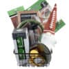 The Football Game Day Gift Basket is a rectangular black wire basket filled with diverse football-themed party items, such as a gnome wearing a football hat, disposable cups, plates, a water bottle, napkins, a short green and white tumbler designed to look like a football field, party bags, and a game day planner.