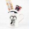 The Friends Mug Gift Basket With Free Food Certificate includes a white ceramic mug featuring a black-and-white illustration of two embracing stick-figure friends labeled "Friends." Inside the mug, you'll find a pair of socks, metallic pink liquid lipstick in its packaging, and a small tube of hand cream with a colorful design—all perfect for creating an adorable gift basket.