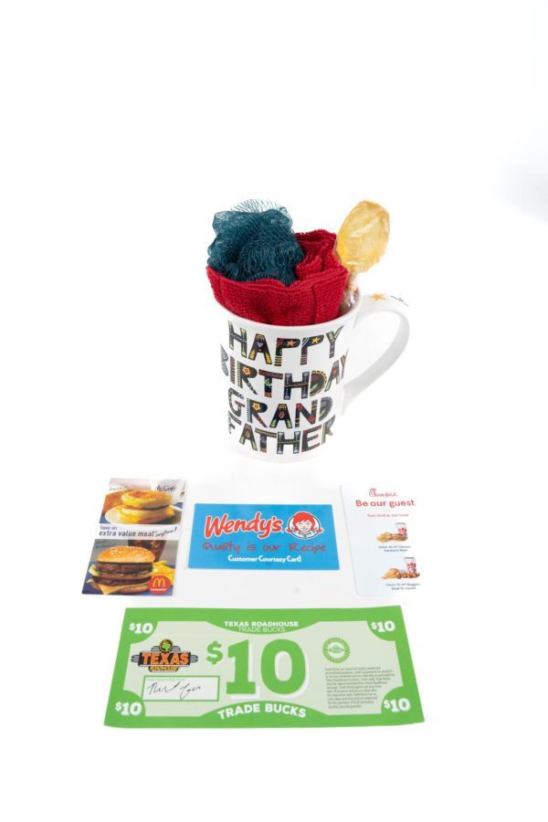 The "Happy Birthday Grandfather" Mug features colorful lettering and is filled with multi-colored socks and a yellow clip. Included below are McDonald's coupons, a Wendy's gift card, a Chick-fil-A coupon, and a Texas Roadhouse $10 trade bucks voucher—perfect free food certificates.