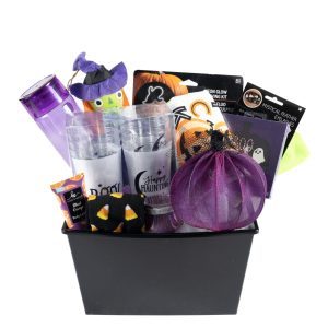 The Halloween Medium is a black basket packed with Halloween-themed items, featuring a purple water bottle, a small pumpkin decoration wearing a witch hat, two transparent cups with the text "Happy Haunting," socks decorated with pumpkins, a trick-or-treat bag, and additional festive accessories.