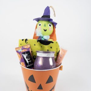 Presenting the **Halloween Pail with Free Food Certificate**: This fun-filled set features an orange bucket adorned with a classic black Jack-o'-lantern face. Inside, you'll find an adorable green-faced witch plush, a cheerful yellow towel, a spooky purple candle, soothing hand cream and body lotion, and a complimentary food certificate—everything arranged neatly against a pristine white background.