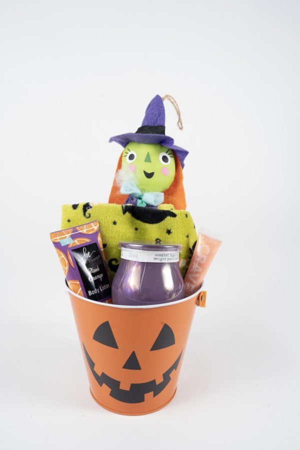 Presenting the **Halloween Pail with Free Food Certificate**: This fun-filled set features an orange bucket adorned with a classic black Jack-o'-lantern face. Inside, you'll find an adorable green-faced witch plush, a cheerful yellow towel, a spooky purple candle, soothing hand cream and body lotion, and a complimentary food certificate—everything arranged neatly against a pristine white background.