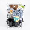 Kitchen and home gift basket including a fleece throw, cutting board, two coffee mugs, and a candle.