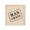 The Man Crate Gift Box is a wooden crate with "MAN CRATE" stenciled in bold black letters on the front, featuring a simple, unfinished look.