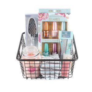 The Manicure/Pedicure Basket features a collection of various beauty and self-care essentials, including nail polishes for a perfect manicure, nail files, a soothing candle, a foot peel mask for an ideal pedicure, and a pair of soft socks. These brightly colored items are neatly arranged in the black wire basket.