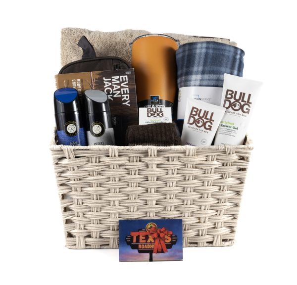 Large Men's Spa Basket with $40 Texas Roadhouse Dinner for Two Certificate: Woven basket filled with grooming products, including two Bulldog skincare tubes, Every Man Jack shaving cream, two AXE body sprays, a blue and gray plaid blanket, a tan towel, and an orange bottle.