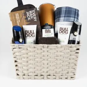 The Adult Gambling Night Basket includes a beige woven basket filled with grooming products such as the Bulldog Original Bamboo Razor, Bulldog Original Shave Gel, Bulldog Original Moisturizer, and Bulldog Original Face Wash. It's perfect for adults prepping for a big night out or winding down after an exciting gambling night.