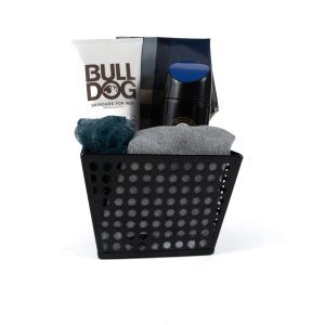 The Men's Spa Bucket with Free Food Certificate includes a stylish black container holding premium men's skincare products: a tube of Bulldog face wash, a sleek dark bottle of deodorant, and a sophisticated silver tube. It also comes with a gray cloth and a dark green loofah, perfect for an indulgent spa day at home. The container features a modern perforated design for added elegance.