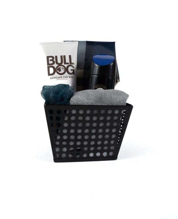 The Men's Spa Bucket with Free Food Certificate includes a stylish black container holding premium men's skincare products: a tube of Bulldog face wash, a sleek dark bottle of deodorant, and a sophisticated silver tube. It also comes with a gray cloth and a dark green loofah, perfect for an indulgent spa day at home. The container features a modern perforated design for added elegance.