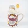 The "Mom We Know I'm Your Favorite Mug Gift Basket with Free Food Certificate" features a white mug adorned with colorful flower designs and the word "MOM" prominently displayed in large letters. Beneath, the text reads, "I Love How We Don't Have to Say Out Loud That I'm Your Favorite." The beloved mug includes a candle and a lollipop wrapped in tulle, making it an ideal addition to any gift basket.