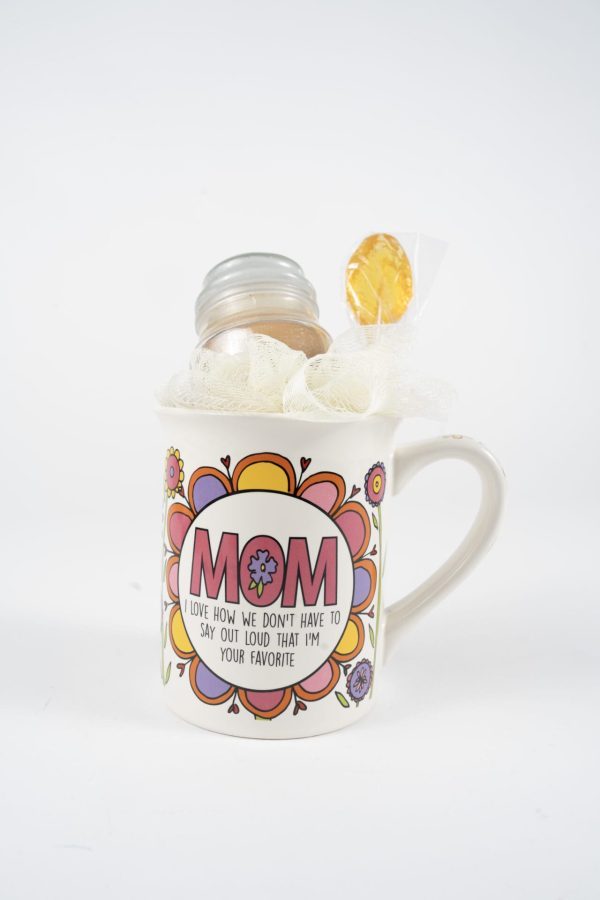 The "Mom We Know I'm Your Favorite Mug Gift Basket with Free Food Certificate" features a white mug adorned with colorful flower designs and the word "MOM" prominently displayed in large letters. Beneath, the text reads, "I Love How We Don't Have to Say Out Loud That I'm Your Favorite." The beloved mug includes a candle and a lollipop wrapped in tulle, making it an ideal addition to any gift basket.