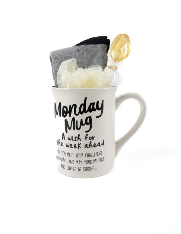 The Monday Mug Gift Basket with Free Food Certificate includes a white mug adorned with the text "A wish for the week ahead. May you meet your challenges with grace and may your patience and coffee be strong..." Inside, you'll find a gray sock, a black sock, a yellow loofah, and a lollipop. This delightful gift basket makes for an ideal start to any week.