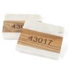 Two rectangular blocks resembling a pair of square coasters, primarily white with a marble-like pattern and a smooth wooden texture in the middle, featuring an engraved zip code "43017." The background is plain white. Product: Pair Square Coasters - Choose any Zip Code.