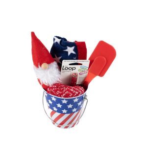 The small Patriotic Pail with red, white, and blue stars and stripes comes filled with a gnome figurine in a red hat, patriotic socks, a red exfoliating glove, a red spatula, Loop Earplugs, and even includes a free food certificate.