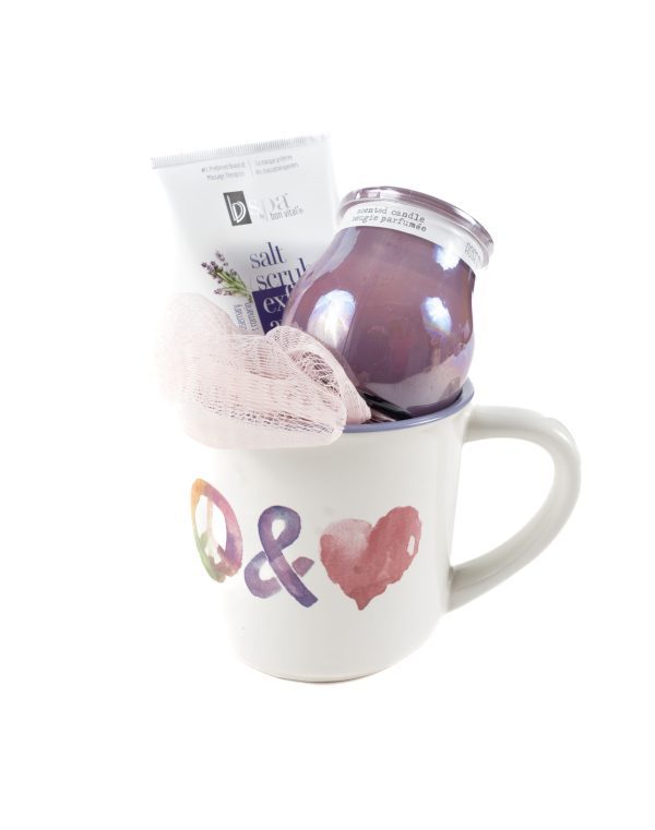 The Peace & Love Mug Gift Basket with Free Food Certificate features a vibrant mug embellished with colorful peace and heart symbols on the front, containing a pink loofah, a jar of lavender-scented candle in purple, and a tube of lavender salt scrub. This gift basket is thoughtfully arranged to provide an inviting and relaxing presentation.