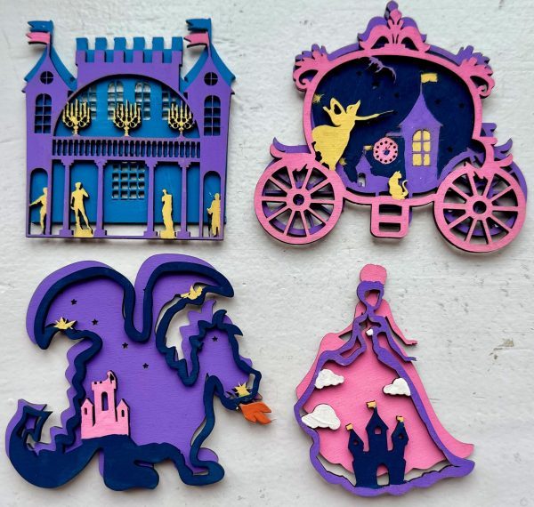 The Princess Craft Kit features four intricately designed, colorful wooden cutouts against a white background. The designs include a castle, a horse-drawn carriage, a fire-breathing dragon, and a princess in a gown, each embellished with silhouettes and golden accents.