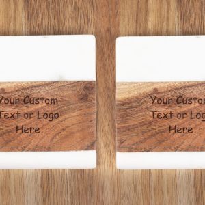 A pair of the "Pair Square Coasters - Your Custom Text/Logo Here" with white tops are placed on a wooden surface. Each coaster features an engraved section that reads, "Your Custom Text or Logo Here." The design beautifully combines wood grain and smooth white material.