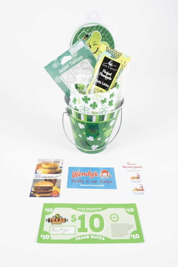 The St. Patrick's Day Pail with Free Food Certificate includes a small green pail adorned with shamrocks, containing various items such as Jewel tattoos and body lotion. Surrounding the pail are McDonald's coupons, a Wendy's customer courtesy card, a Texas Roadhouse free food certificate, and a St. Patrick's Day thank you note.