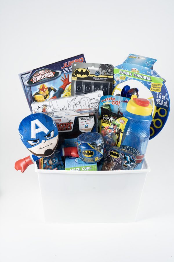 Introducing the Adult Gambling Night Basket—a white basket brimming with various children's toys themed around superheroes. Inside, you'll find a plush Captain America head, Batman action figures, a Marvel puzzle, a water bottle, a coloring book, a bubble pinwheel, and an assortment of character-themed toys and games—perfect for keeping both kids and adults entertained throughout the night.