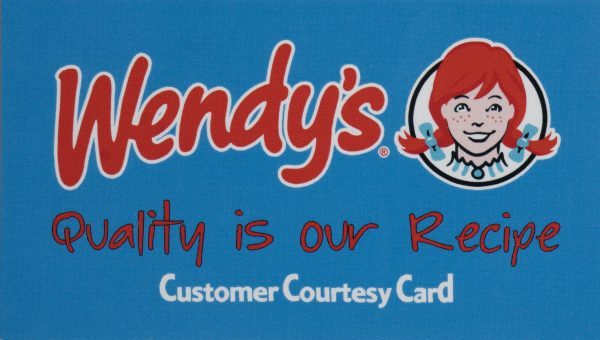 A blue card with the Wendy's logo in red, featuring the name "Wendy's" and a drawing of a smiling red-haired girl. The text below the logo reads "Quality is our Recipe" in red and "Customer Courtesy Card" in white. It's a perfect addition to the "You are my BFF Mug Gift Basket with Free Food Certificate," making it an ideal gift for fast-food lovers.