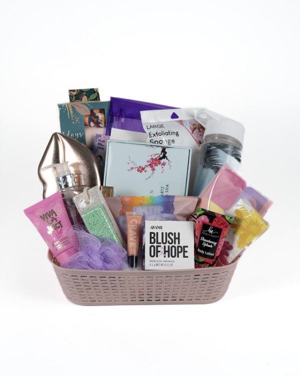 The Adult Gambling Night Basket is a thoughtful gift that includes various personal care essentials such as perfumes, lotion, an exfoliating sponge, a water bottle, a loofah, a candle, nail care products, and a notebook. Ideal for adults looking to unwind after an evening of entertainment. The items come in vibrant packaging within an elegant beige lattice pattern basket.