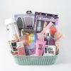 An Adult Gambling Night Basket contains various pampering items, including a water bottle, bath crumbles, a pair of foot files, a mermaid-themed nail polish set, a bottle of Blush of Hope liquid, a bar of soap, a lip scrub, and a Viva La Juicy travel fragrance.