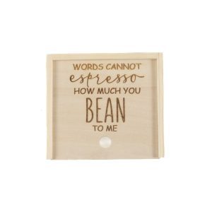 The *Gift Box - Words Cannot Express How Much You Bean to Me* features a wooden sign with a coffee-themed pun: "Words cannot espresso how much you bean to me." Engraved in a playful mix of cursive and block letters, this simple and rustic sign also includes a small round hook at the bottom center, making it an ideal gift for any coffee enthusiast.