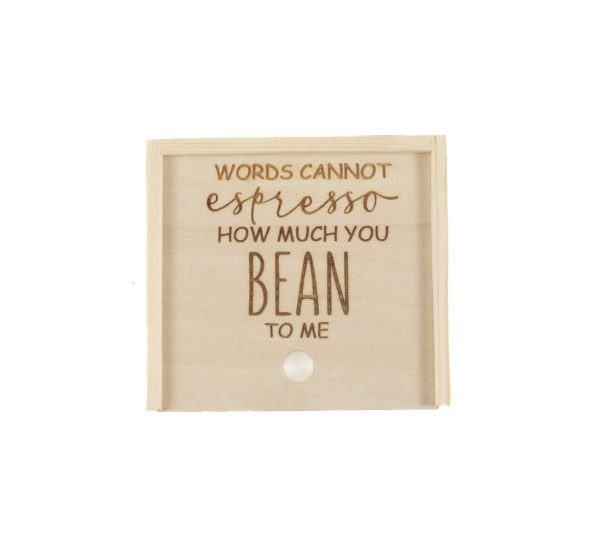 The *Gift Box - Words Cannot Express How Much You Bean to Me* features a wooden sign with a coffee-themed pun: "Words cannot espresso how much you bean to me." Engraved in a playful mix of cursive and block letters, this simple and rustic sign also includes a small round hook at the bottom center, making it an ideal gift for any coffee enthusiast.