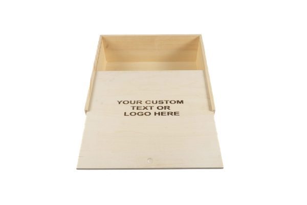 A light Wooden Gift Box - Large Crate, partially open with a sliding lid. The lid is slightly pulled out, revealing an empty interior. On the lid, the phrase "YOUR CUSTOM TEXT OR LOGO HERE" is printed in dark, bold letters.