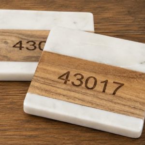 Personalized marble and wood square coasters engraved with custom zip code