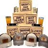 A display of wooden crates labeled "Groom Man Crate," "Ring Bearer Crate," "Best Man Crate," and "Father in Law Crate." Each Groom Man Crate - Wooden Gift Box includes a flask, caps with emblems, a pint glass, and a bottle opener.