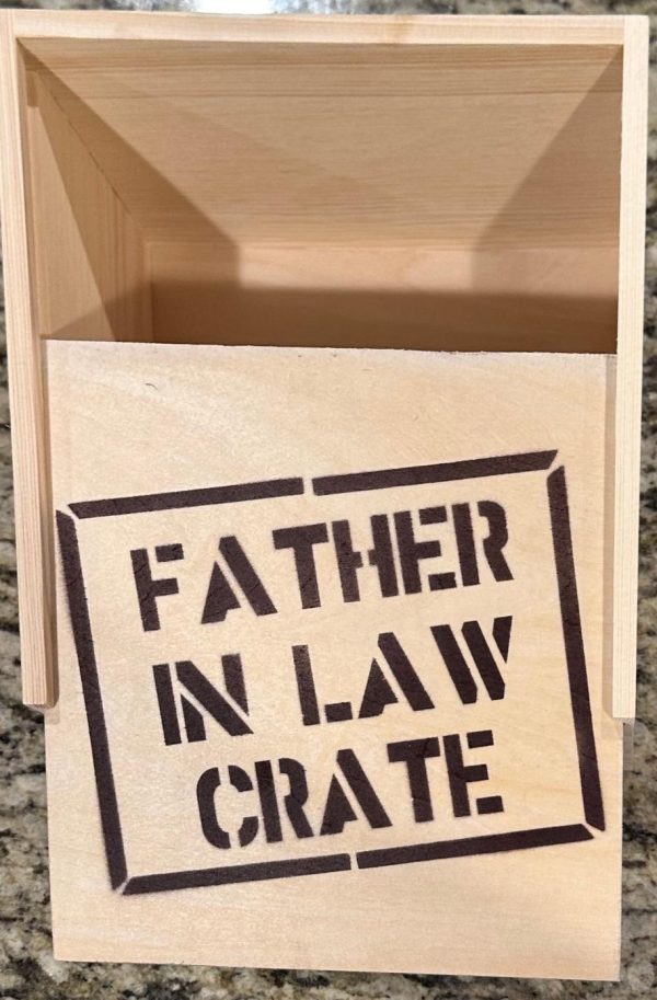 A Father In Law Crate - Wooden Gift Box with the product name "Father In Law Crate" stenciled in black on the front. The empty wooden gift box sits open on a granite countertop, ready to be filled.