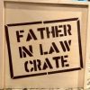 The image showcases a charming "Father In Law Crate - Wooden Gift Box" sitting on a countertop. A close-up of the front of the wooden crate highlights the bold, uppercase letters stenciled with the words "FATHER IN LAW CRATE.