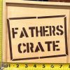 A Fathers Crate - Wooden Gift Box is seen with yellow measuring tapes placed vertically and horizontally next to it. The crate appears to be approximately 10 inches tall and 15 inches wide, based on the measurements shown by the tapes.