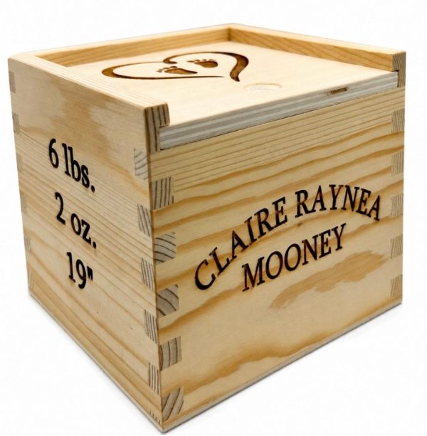 Personalized baby keepsake box made of wood with custom engraved birth information for a new baby gift.
