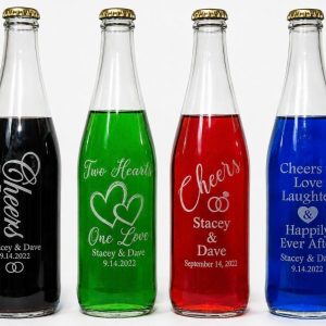Personalized 12oz glass wedding favor bottles with custom logo engraving and gold lids.